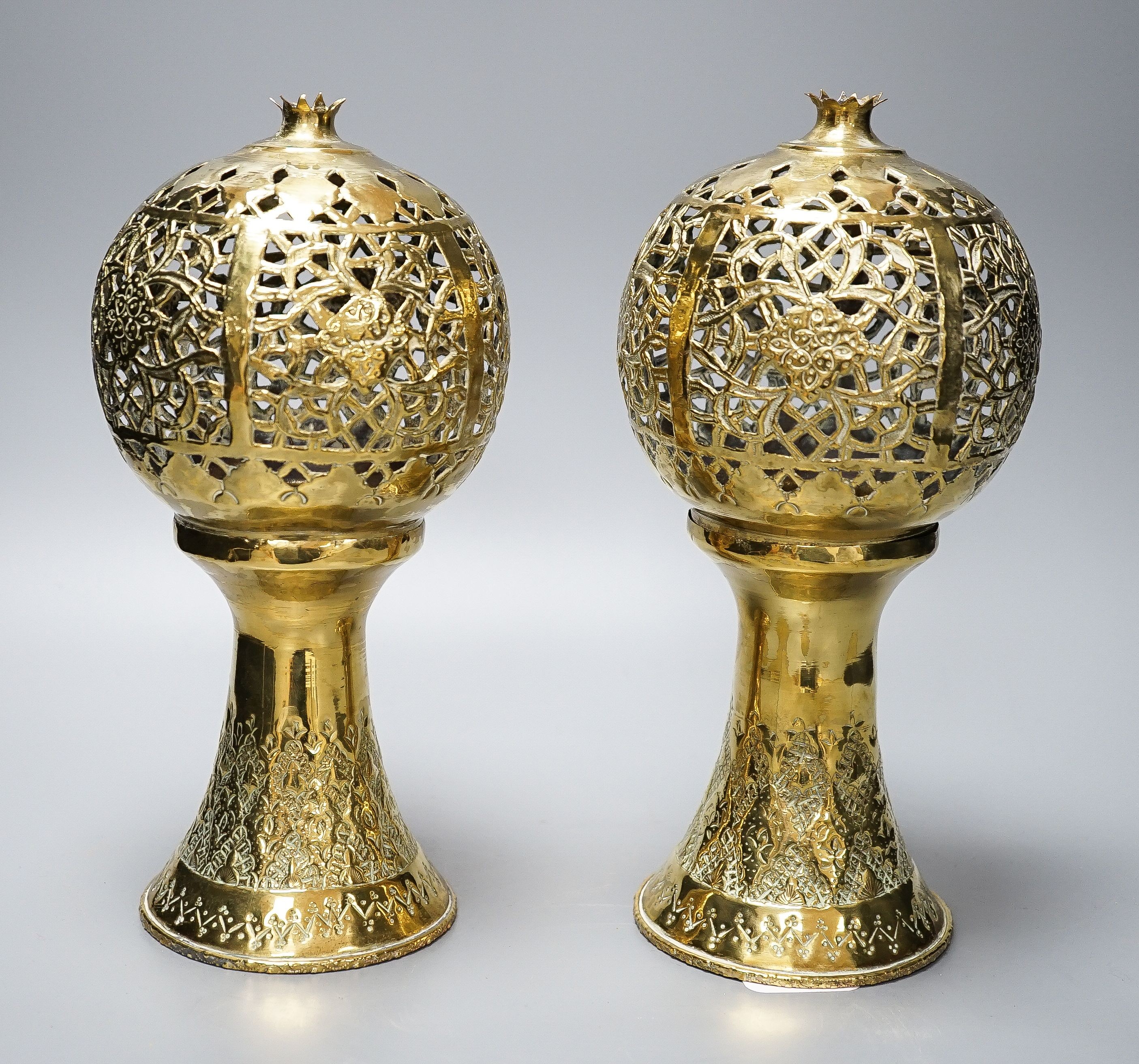 A pair of Indian brass incense burners, each of pomegranate form, 28cm